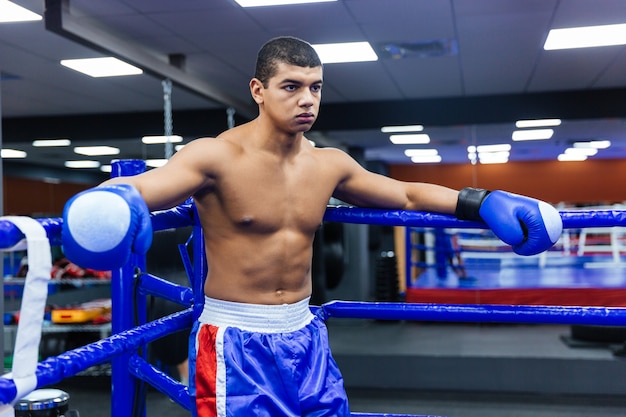 Male boxer standing in the corner of the boxing ring