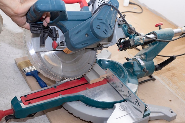 male builder carpenter sawing a circular saw