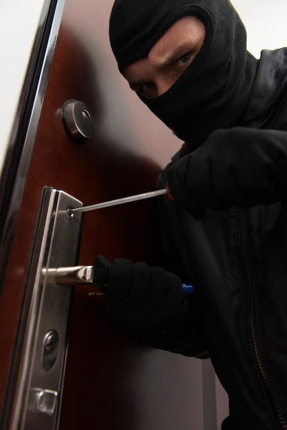 Male Burglar In Mask Breaking Into The House