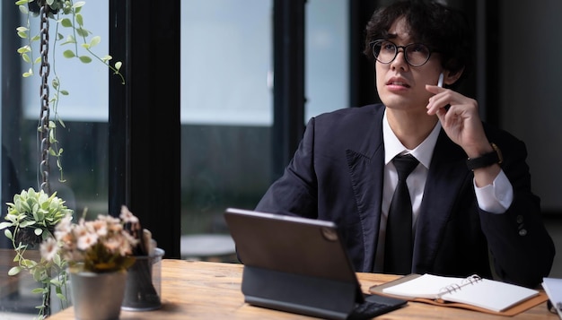 사진 male business investor looking financial data and investment plan on tablet computer in the office