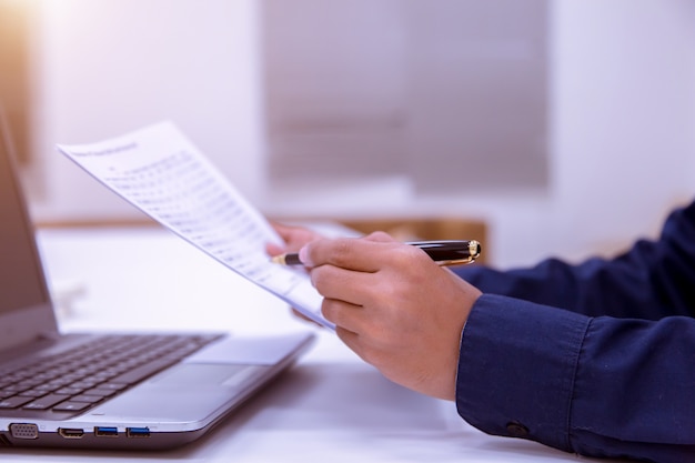 Photo male business man reading a document to make a financial statement with the bank.