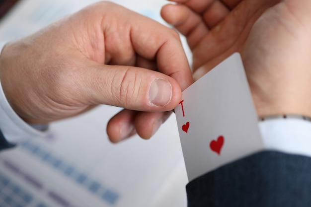 Male businessman hand hold playing card in hand