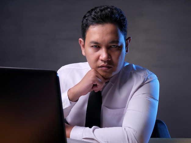 male businessman looking at camera with cynical look