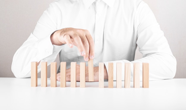 Male businessman, wooden blocks. a concept about career growth, insurance