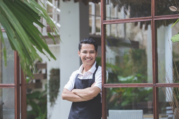 Male cafe worker smiling