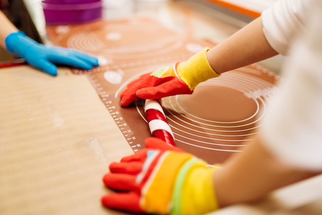 Male chef hands in gloves, caramel making process