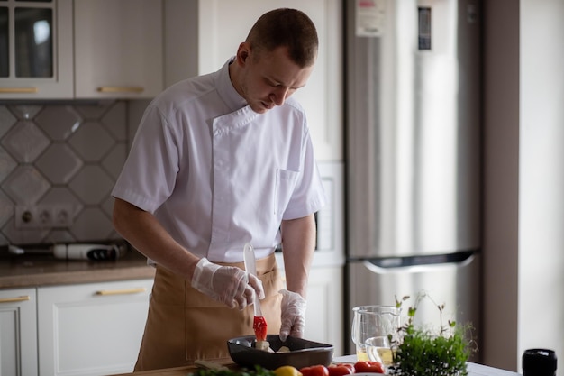 Male chef handsome young man preparing healthy food