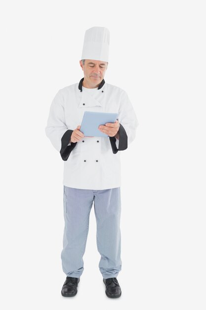 Male chef looking at digital tablet