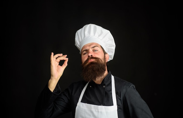 Male chef in uniform professional chef man showing sign for delicious cook with taste approval