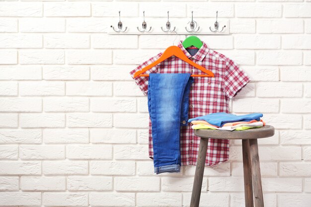 Male clothes on hangers in a room