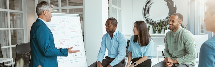 Photo male coach or speaker make flip chart presentation to diverse businesspeople at meeting