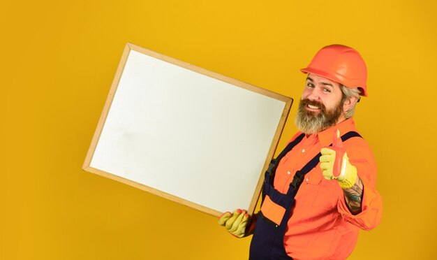 Male construction worker copy space planning new project man with presentation Builder with flipchart Architect worker hold flip chart presenting flipchart at meeting thumb up for success
