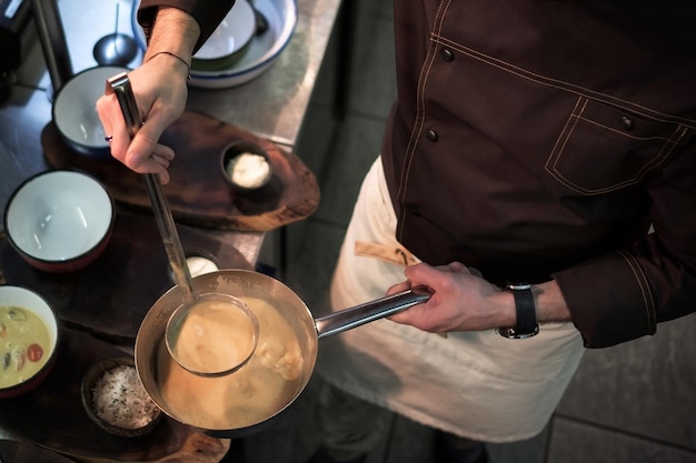 Male cook serve delicious meal in restaurant