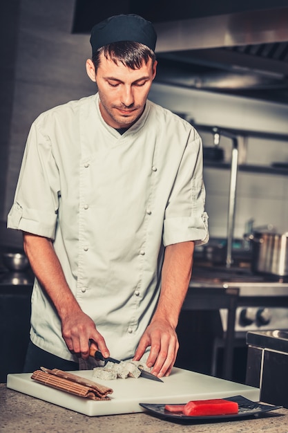 Male cooks preparing sushi in the restaurant kitchen