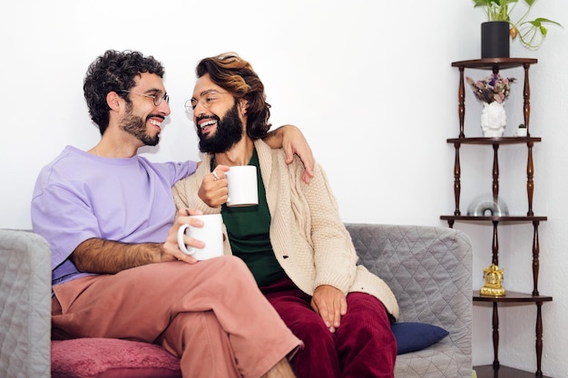 Male couple smiling relaxed on the couch at home