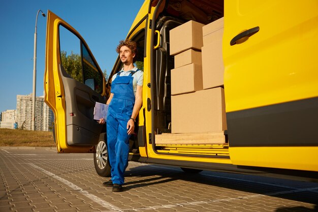 Male courier providing cargo delivery or home office moving service