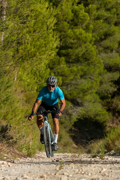 A male cyclist in a gravel road bicycle ride in the mountains of Costa Blanca Alicante Spain