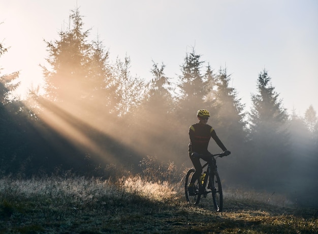 Male cyclist riding bicycle in the morning