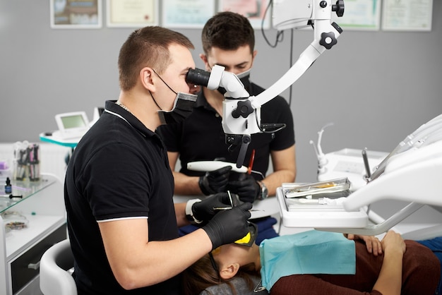 Male dentist performs dental checkup