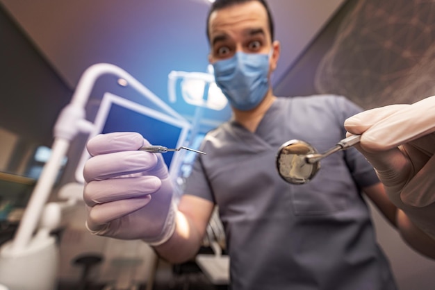 Male dentist with tools