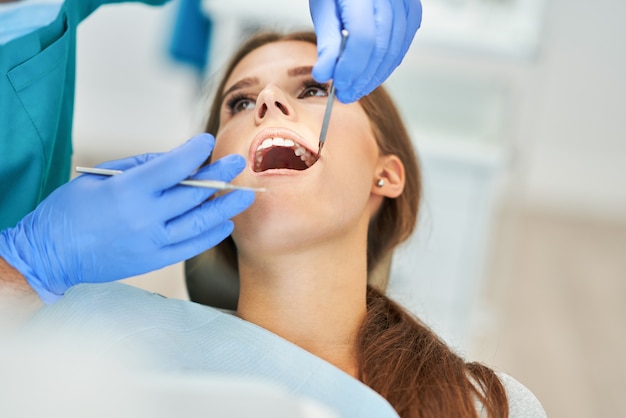 Male dentist and woman in dentist office