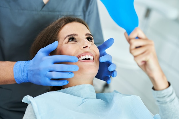 Male dentist and woman in dentist office