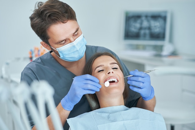 Male dentist and woman in dentist office