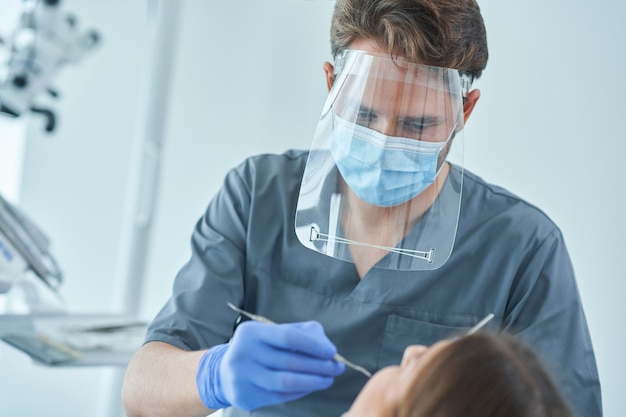 Male dentist and woman in dentist office