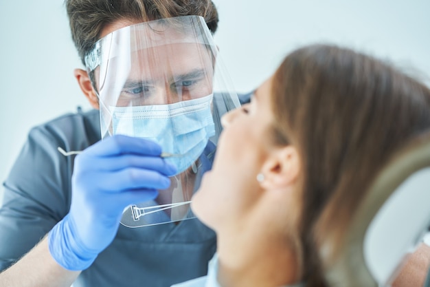 Male dentist and woman in dentist office