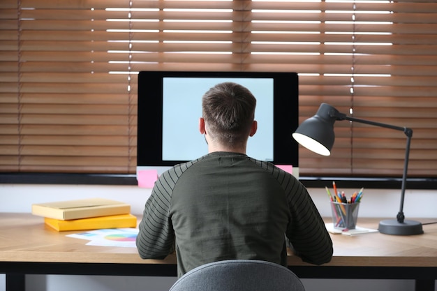 male designer working at desk in office