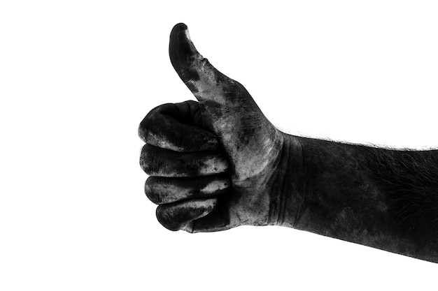 Male dirty black hand showing class isolated on white wall, black and white graphy