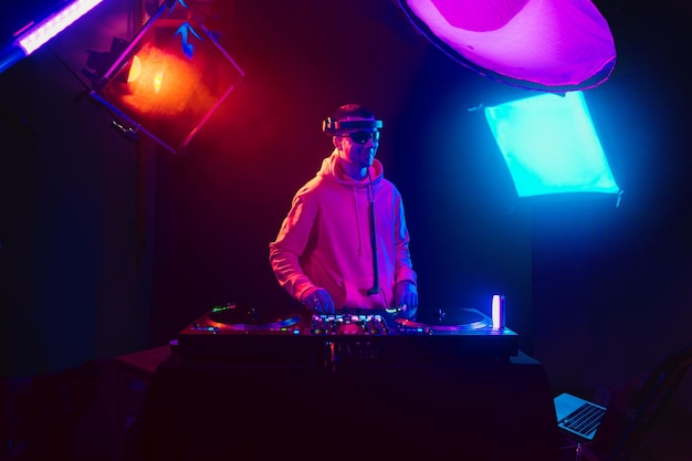 Male dj playing music in the night club