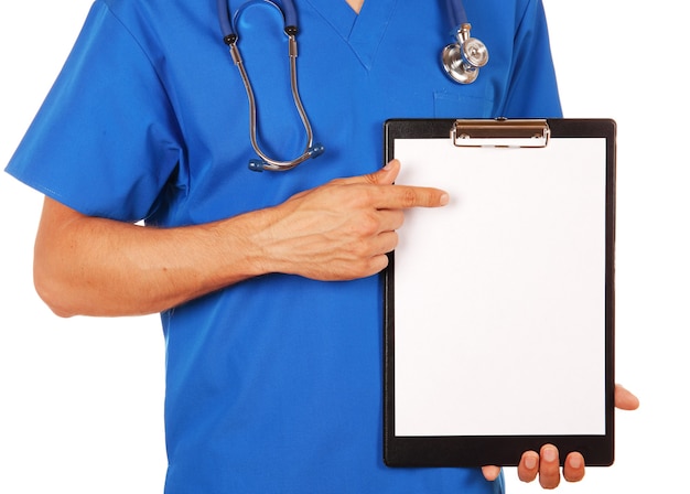 Male doctor in blue uniform with stethoscope showing blank clipboard to write it on your personal message or advice