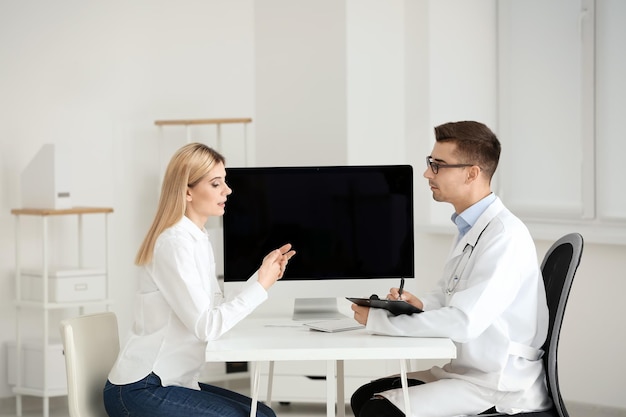 Male doctor consulting patient in clinic