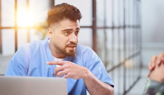 male doctor consulting patient filling form at consultation