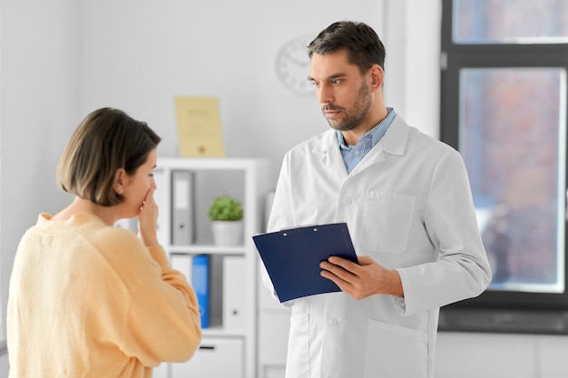 male doctor and coughing woman at hospital