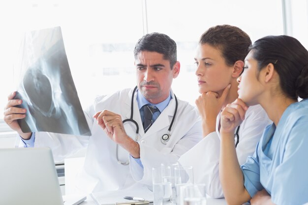 Male doctor discussing xray with colleagues