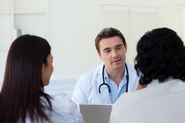 Male doctor explaining diagnosis to a couple