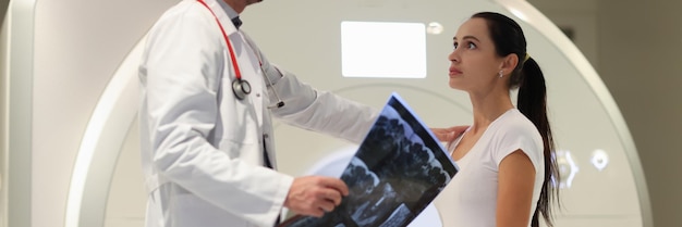 Male doctor explaining to female patient result of mri examination in clinic diagnostics and