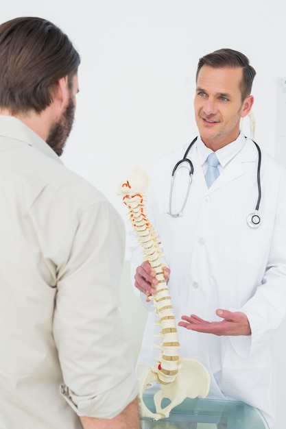 Male doctor explaining the spine to a patient