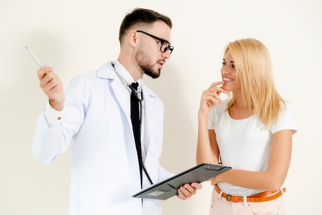 Male Doctor and Female Patient in Hospital Office