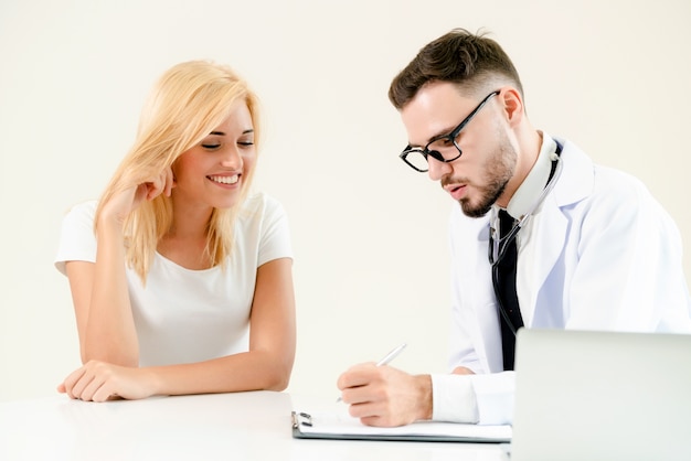 Male Doctor and Female Patient in Hospital Office