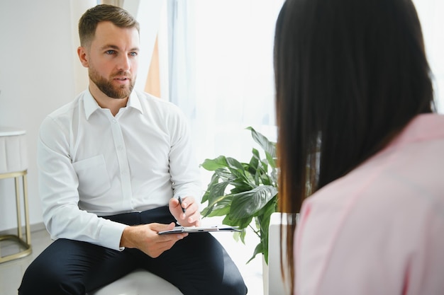 Male doctor and female patient at therapy session