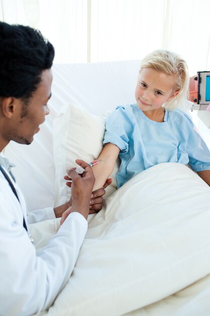 Male doctor giving a child patient an injection 