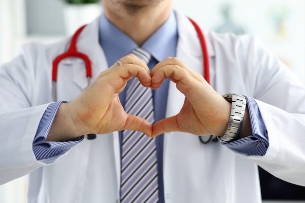 Male doctor hands showing heart shape closeup