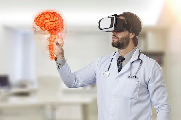 Male doctor in his office, using a Virtual Reality Glasses, looking at a virtual brain