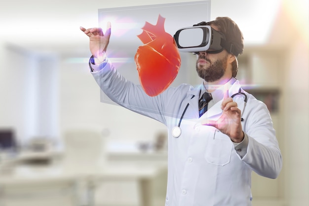 Male doctor in his office,using a Virtual Reality Glasses, looking at a virtual heart