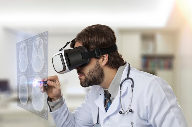 Male doctor in his office, using a Virtual Reality Glasses, looking at a virtual screen