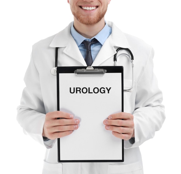 Male doctor holding clipboard with word UROLOGY on white background closeup