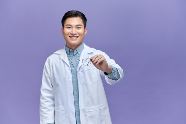 Male doctor holding pair eyeglasses his hands